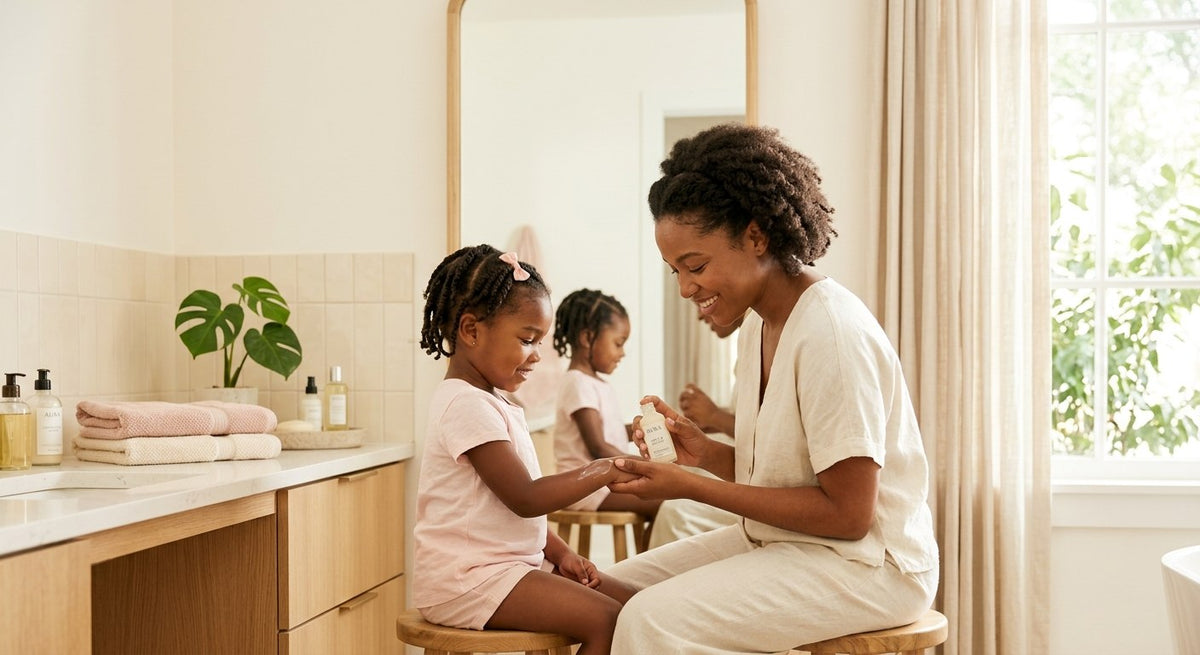Mother and daughter applying lotion together